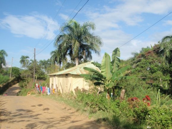 A house on a dirt road in the Dominican Republic.