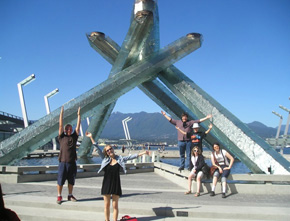 Roots members in front of the Olympic Couldron in Vancouver