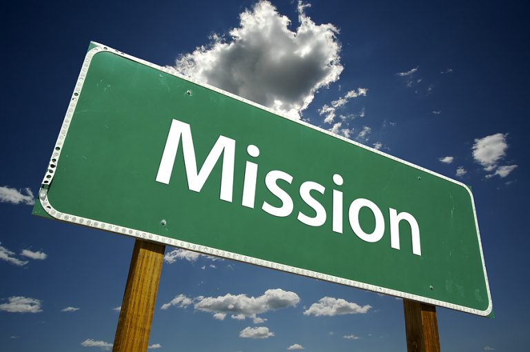 Mission Sign against Clouds