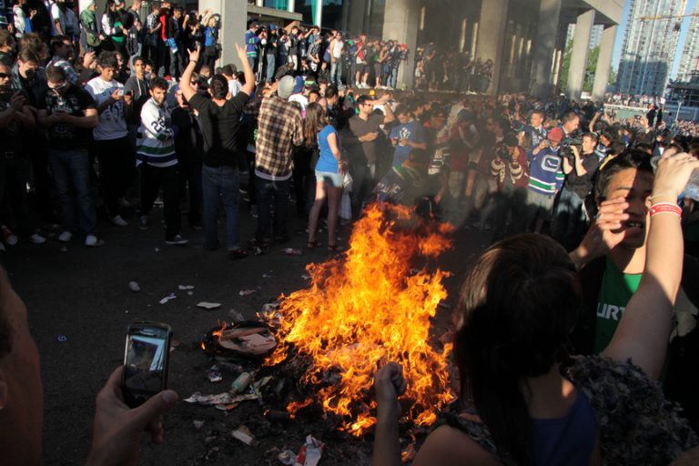 Bystanders taking pictures of a fire in Vancouver