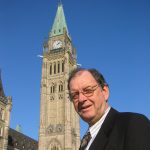 Lloyd Mackey in front of the Peace Tower on Parliament Hill in Ottawa