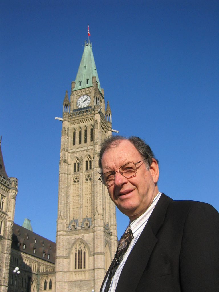 Lloyd Mackey in front of the Peace Tower on Parliament Hill in Ottawa