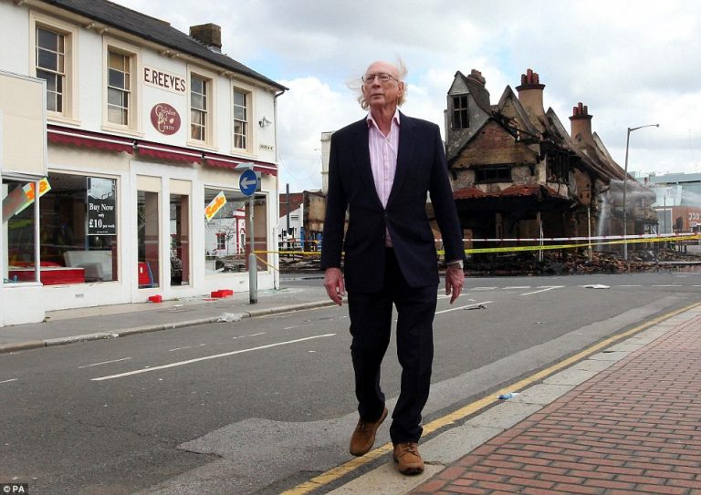 Maurice Reeves outside his burned out 140-year old furniture store in Croydon